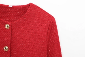 Close-up of red tweed jacket featuring gold buttons and metallic texture detail