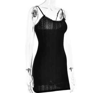 Detail of black cotton mini dress featuring delicate lace V-neck and ribbed texture