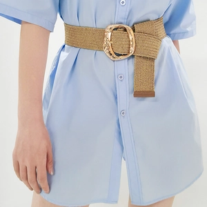 Khaki woven elastic wide belt with textured gold buckle shown on a blue shirt dress