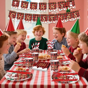 Happy children at table with Merry Christmas themed plates cups and banners