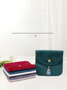Detail of velvet jewelry pouches with gold snap buttons in multiple colors for storage