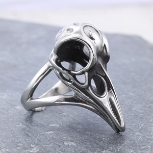 Gothic punk bird skull ring in silver stainless steel on a dark natural slate background