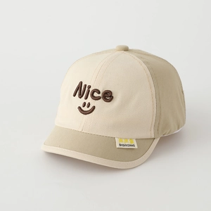 Close-up of a two-tone beige kids baseball cap with nice embroidery and a smile face