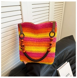 Detail of rainbow straw tote with brown handles and dark wooden bead connections