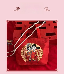 Detail of red wedding canvas bag with festive illustration and elegant pearl accents