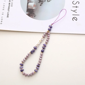 Close-up of handmade purple crystal beaded phone wrist strap with gold LOVE letter charms