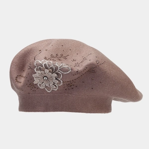 Dettaglio del fiore 3D laterale e degli strass di cristallo sul berretto in maglia