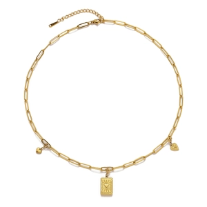 Detail of golden paperclip chain necklace with heart and textured rectangular charms