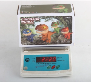 5-in-1 dinosaur stationery set in retail packaging shown on a digital scale
