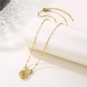 Golden reindeer antler necklace with zircon projection stone on white pedestal