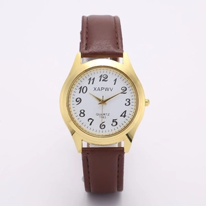 Detailed view of quartz watch with brown leather strap and gold metal case on white backdrop