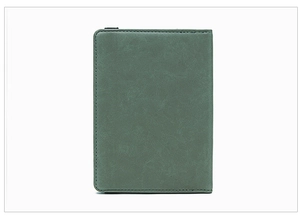 Detail of sage green RFID passport holder with precision stitching and matte texture