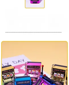 Close-up of colorful Lucky Slot machine keychains in metallic gold, pink, blue, and purple