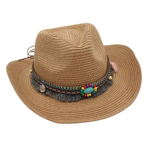 Detail of straw cowboy hat with turquoise stone and fringe beaded ethnic band