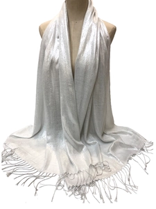 Close-up of white shawl with silver metallic thread and delicate fringe details