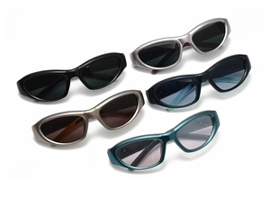 Close-up of stylish oval frame sunglasses in various matte and metallic color finishes