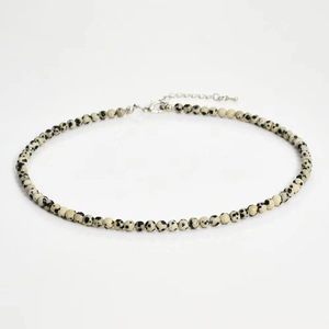 Detail of 4mm spotted natural stone beaded necklace with silver lobster clasp and chain