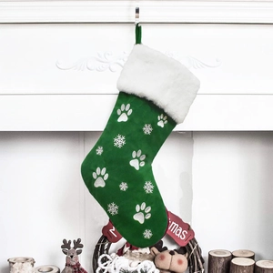 Green Christmas stocking with white faux fur cuff, embroidered paw prints and snowflakes