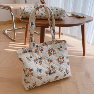 Quilted cotton tote and pouch set with vintage bear print on a wooden table