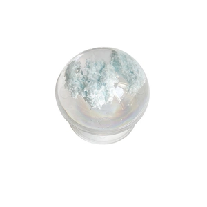 Minimalist transparent crystal ball phone grip with blue cloud decor on white background