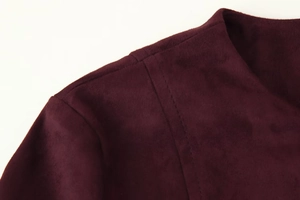 Detail of dark burgundy faux suede jacket showing high-quality stitching and fabric texture