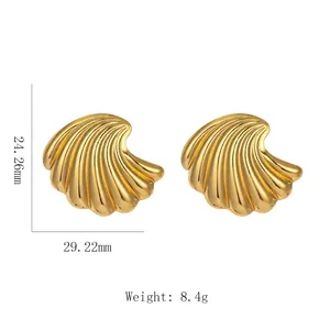 Macro detail of gold fan earrings with shell-like texture and size dimensions shown