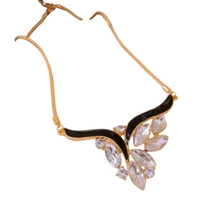 Vintage wing pendant necklace with sparkling diamonds and black enamel in golden finish