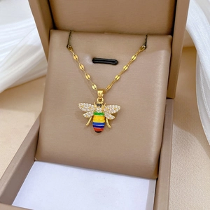 Detail of bee necklace with zircon wings and multicolored stripes in jewelry box
