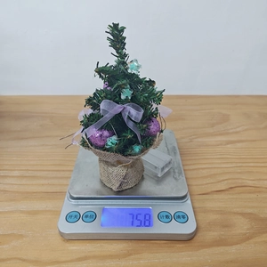 Mini Christmas tree ornament with ornaments and burlap base shown weighing 75.8g
