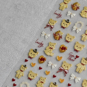 Macro detail of 3D embossed teddy bear nail stickers with Lucky and Cute Bear text