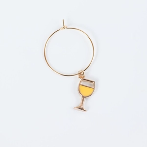 Detail of wine glass charm with a golden ring and yellow goblet pendant on white back