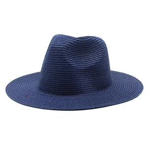 Classic dark blue straw fedora hat for summer sun protection with woven texture