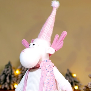 Detail of pink Christmas reindeer plush with sequin scarf and knit texture ornament