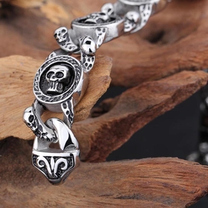 Macro detail of punk skull bracelet with vintage black oil finish and floral clasp