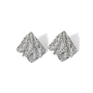 Detailed view of silver stainless steel earrings featuring irregular textured fold patterns