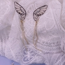 Detailed view of S925 silver butterfly wing earrings with long crystal tassels on lace