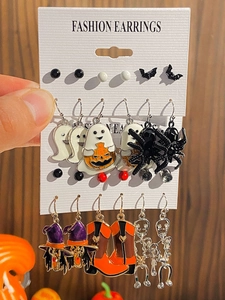 Close-up of Halloween earrings set with ghost, bat, and spider motifs on a card