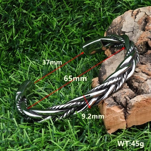 Detail view of woven C-shape silver bracelet with 37mm opening and 9.2mm width