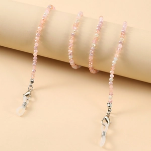 Macro view of colorful beaded eyeglass chain with pale pink and iridescent crystals