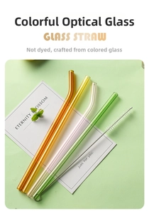 Detailed view of colorful heat-resistant glass straws with a stainless cleaning brush