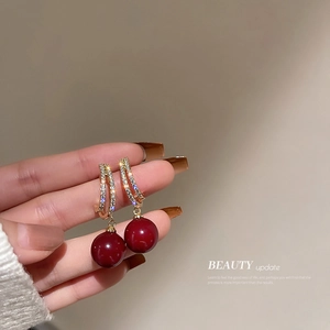 Elegant gold drop earrings with deep red beads and sparkling pavé crystals