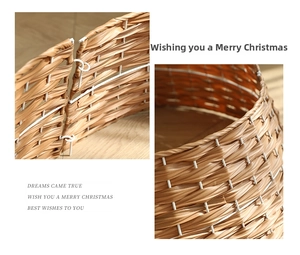 Close-up of brown woven Christmas tree fence detail showing metal frame and buckle