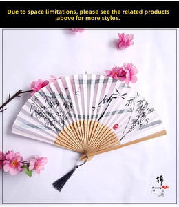 Detailed close-up of a bamboo folding fan with ink bamboo prints and a black silk tassel