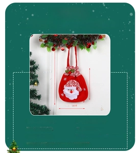 Detail of Christmas candy bag with 3D Santa Claus figure and red drawstring handle