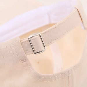Detail of adjustable metal buckle and cotton inner sweatband on kids baseball cap