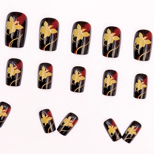 Artistic floral press-on nails with black base and red-yellow pattern, short square oval shape