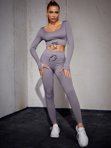 Detail of ribbed purple yoga set featuring drawstring waist and thumbhole sleeves
