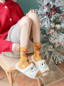 Détails de chaussettes de Noël jaunes à motifs de rennes avec des chaussons blancs doux