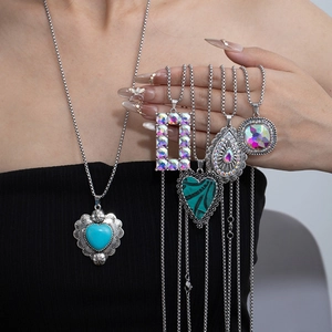 Detail of silver chain necklaces featuring various turquoise pendants in heart and geometric shapes