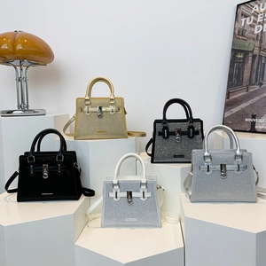 Fashion rhinestone handbag collection in gold, black and silver displayed on pedestals